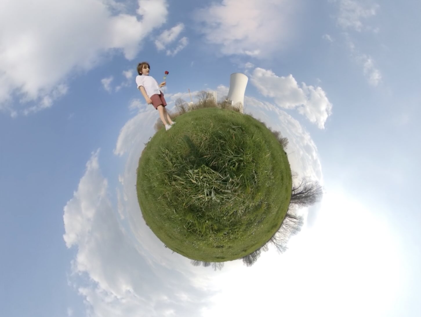A video that shows a boy sticking a rose in the chimney of a power plant