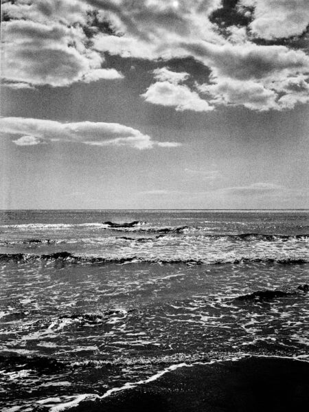 Fine art picture showing waves running out on a beach in black and white