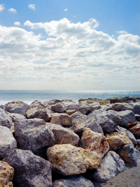 Fine art picture showing the sea behind a rocky wall