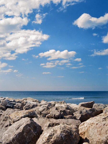 Fine art picture showing a little wave behind a huge rocky wall
