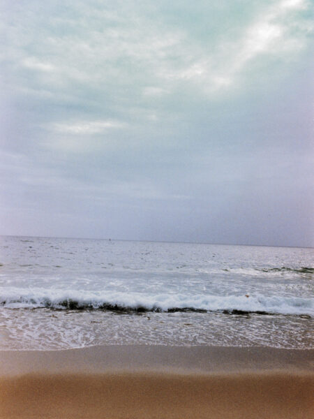 Fine art picture showing beach with a calm sea in misty weather